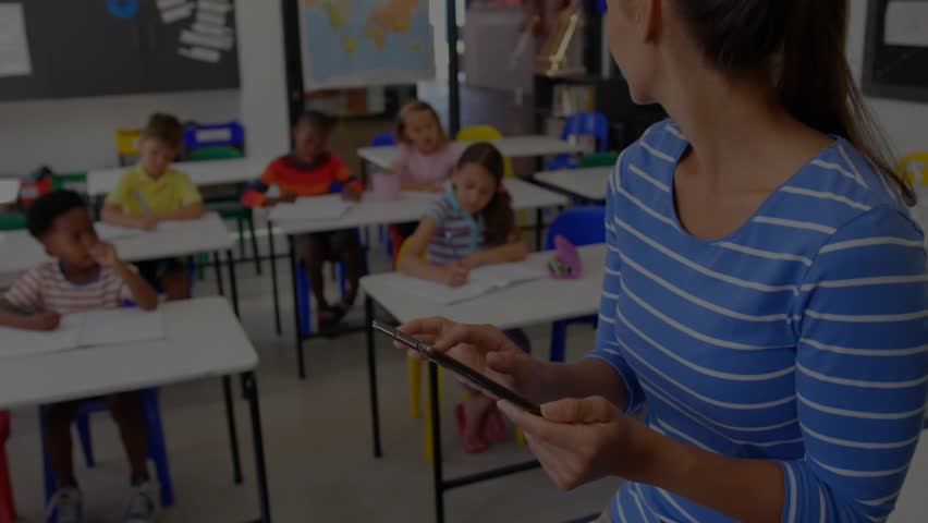Teacher checking tablet, students writing notes, red lock icon fading overlay showing secure link. Education, classroom, digital, security, learning, technology, communication - Powered by Shutterstock - Get 15% off with code: PIKWIZARD15