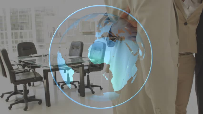 Corporate female executive extending arm into hologram globe showing reach with colleagues huddling. Collaboration, teamwork, innovation, digital, diversity, leadership, networking - Powered by Shutterstock - Get 15% off with code: PIKWIZARD15