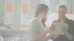 Two women reviewing tablet in business lounge, tapping screen and activating animated data charts. Collaboration, teamwork, corporate, digital, modern, communication, innovation - Powered by Shutterstock - Get 15% off with code: PIKWIZARD15