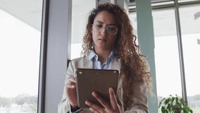 Woman tapping tablet screen creating user-profile network overlay growing over business office view. Futuristic, technology, innovation, digital, connectivity, professional, urban - Powered by Shutterstock - Get 15% off with code: PIKWIZARD15