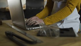 Mid-adult woman typing on laptop, notification icons rising then fading showing social media surge. Craftsman, workspace, digitalinteraction, innovation, creativeindustry, minimaliststyle, - Powered by Shutterstock - Get 15% off with code: PIKWIZARD15