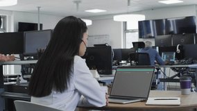 Woman working on laptop, colleague tapping tablet spawning tech charts as she analyzing data. Technology, innovation, digital, futuristic, collaboration, data visualization, workstation - Powered by Shutterstock - Get 15% off with code: PIKWIZARD15