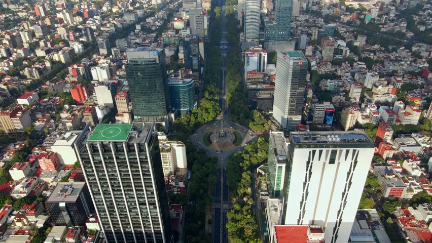 Aerial view showing Paseo de la Reforma on a sunny day with modern buildings and green trees in Mexico City CDMX