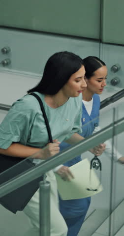 Doctor, emergency and stairs with nurse in hospital for medical, running or sign in rush. Arrive, healthcare and urgency with quick women on steps in clinic together for accident, crisis or disaster