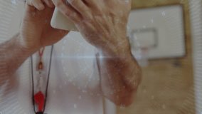 Coach tapping tablet and analyzing digital training metrics overlay on basketball court. Technology, sports, training, analytics, digital, professional, performance - Powered by Shutterstock - Get 15% off with code: PIKWIZARD15