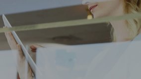 Woman tapping tablet, activating technology HUD showing waveform metrics tracking progress. Futuristic, interface, technology, data, digital, innovation, workspace - Powered by Shutterstock - Get 15% off with code: PIKWIZARD15