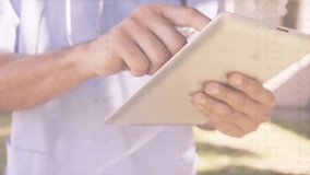 Doctor tapping tablet screen outside clinic and reviewing patient data, scrolling vital signs graph. Medical, healthcare, technology, outdoor, professional, innovation, data - Powered by Shutterstock - Get 15% off with code: PIKWIZARD15