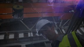 Engineer retrieving tablet under crane activating AR and projecting graphs analyzing manufacturing. Industrial, technology, futuristic, data, digital, engineering, manufacturing - Powered by Shutterstock - Get 15% off with code: PIKWIZARD15