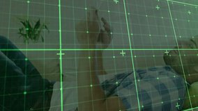 Man lying on couch unlocking smartphone tech demo overlaying green grid animating as scrolling feed. Casual, relaxation, digital, modern, interior, comfort, connectivity - Powered by Shutterstock - Get 15% off with code: PIKWIZARD15