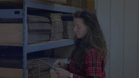 Warehouse worker using tablet projecting waveforms scanning shelves grabbing sheets syncing stock. Technology, logistics, organization, digital, industrial, efficiency, inventory - Powered by Shutterstock - Get 15% off with code: PIKWIZARD15