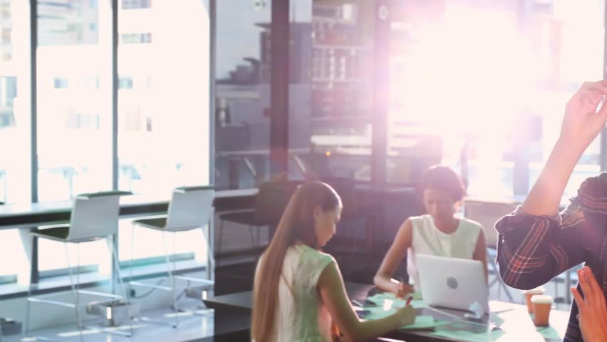 Foreground woman adjusting eyeglasses and activating data overlays enhancing business analysis. Collaboration, innovation, technology, digital, analytics, teamwork, modern - Powered by Shutterstock - Get 15% off with code: PIKWIZARD15