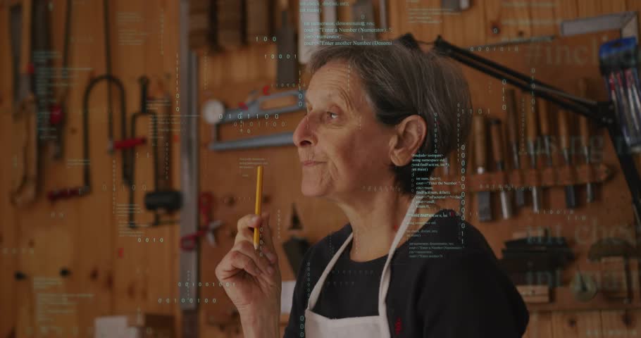 Senior woodworker raising yellow pencil to eye level sketching f-hole outlines on instrument body. Craftsmanship, artistry, woodworking, precision, traditional, hobby, studio