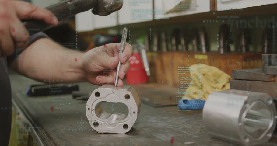 Machinist placing drift punch into housing tapping hammer driving sleeve out in machining workshop. Industrial, metalwork, craftsmanship, precision, manual, workshop, engineering