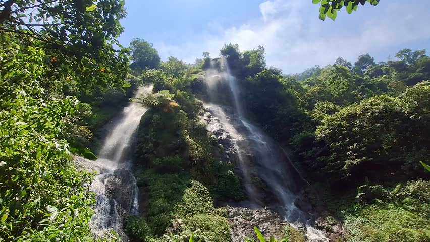 Aerial view of Wangun Waterfall in Subang, West Java, Indonesia. The tallest waterfall in West Java, standing 220 meters high, cascading beautifully over a mountain cliff with three natural tiers.