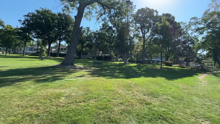Walking On The Grassy Lawn Of With Trees On A Sunny Day In Lake Geneva, Wisconsin, USA. - POV shot