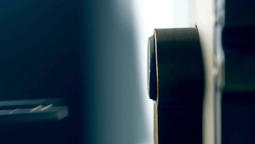 Extreme close up of a key being inserted and turned in a door lock. A macro view of unlocking a deadbolt. Concept of home security and access.