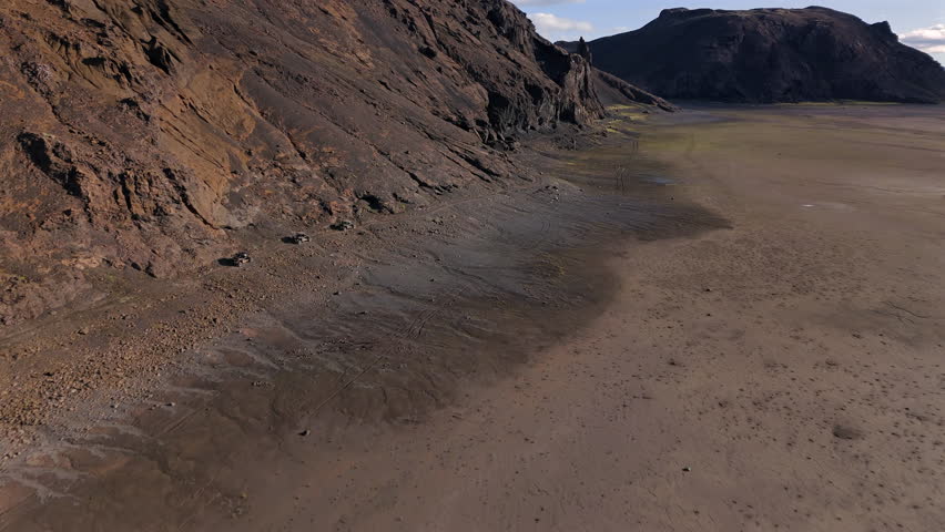 Offroad cars moving along mountain valley