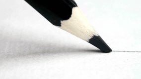 An extreme close up macro shot of a black pencil tip drawing a continuous straight line on white paper. Concept of art, creativity, and education. - Powered by Shutterstock - Get 15% off with code: PIKWIZARD15