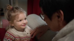 Grandmother telling a Christmas story to her grandson on a cozy winter night. Warm lights, love, and holiday magic create a touching family moment at home. - Powered by Shutterstock - Get 15% off with code: PIKWIZARD15