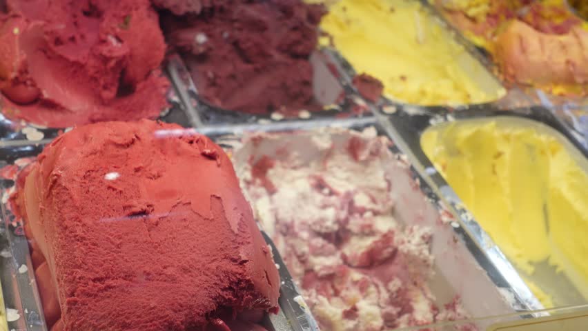 Close up of different flavors of ice cream in a display case 4k