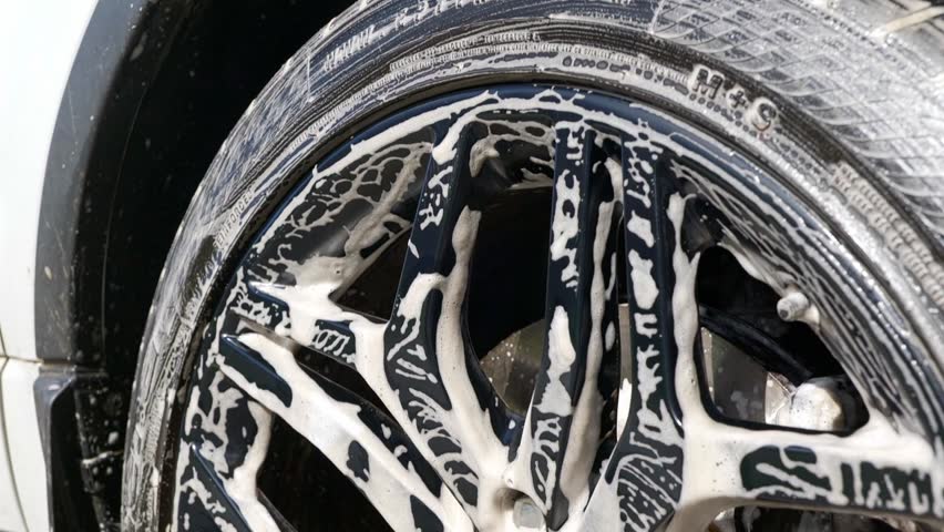 Dirty shampoo suds on black wheen after cleaning - top to bottom