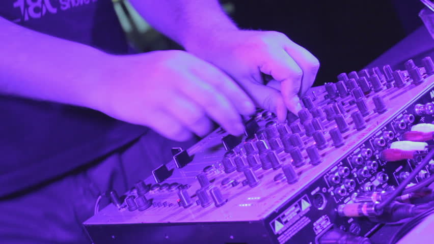 Male Dj hands making music at party in night club