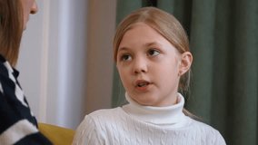 Loving mother and daughter sharing an intimate moment, engaging in deep conversation while sitting comfortably on yellow sofa, expressing genuine emotions and understanding within family dynamic - Powered by Shutterstock - Get 15% off with code: PIKWIZARD15