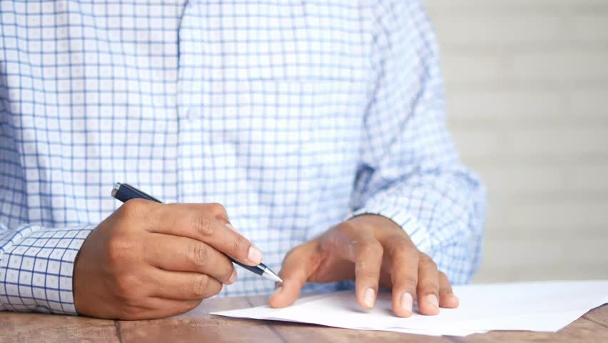Person signing a document 4k video