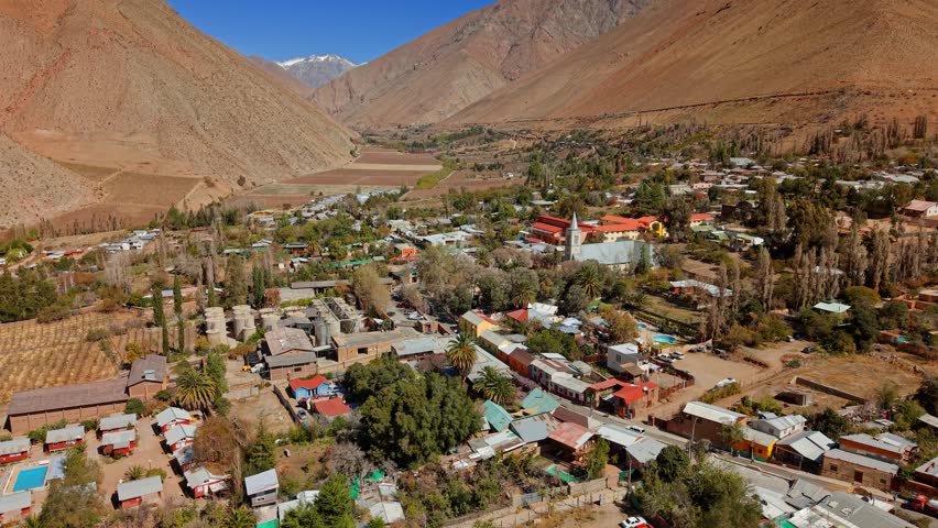 Aerial establishing fly Pisco Elqui town, at Elqui Valley in Chile, Andean Cordillera Mountain landscape