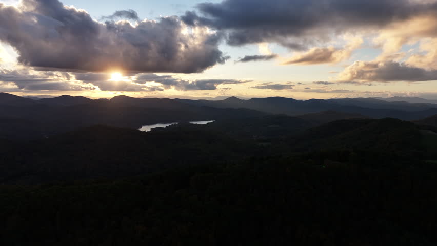 Cinematic aerial view of the Blue Ridge Mountains in autumn, capturing the sun setting.