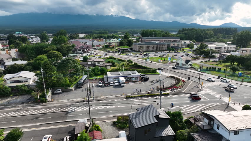 Cloud-capped Mount Fuji As Seen From Scenic Town Of Hakone In Kanagawa Prefecture, Japan. aerial sideways shot