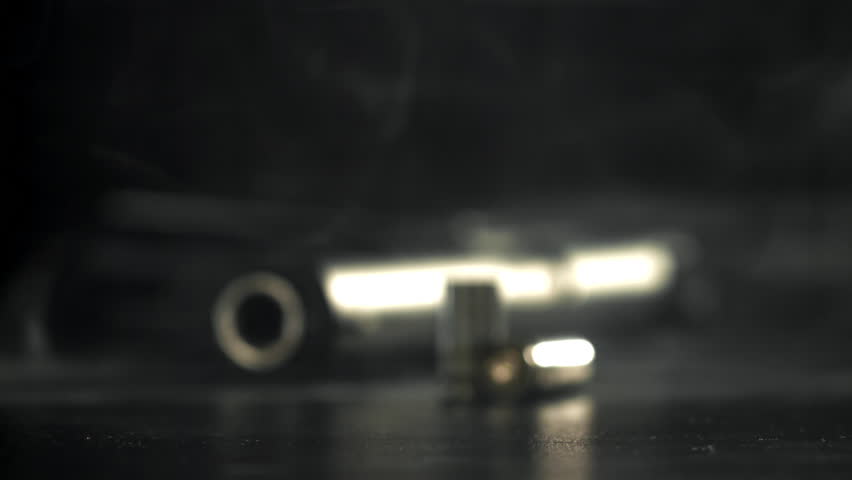 Bullet casings are pressed on the table. Filmed on a high-speed camera at 1000 fps. High quality FullHD footage