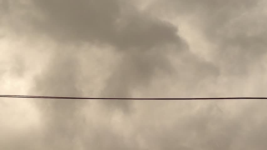 rain and cloudy sky in the afternoon. view of cloudy sky with electric wires. cloud moving.