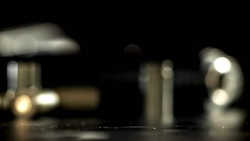 Cartridges from a pistol shot fall to the floor. Filmed on a high-speed camera at 1000 fps. High quality FullHD footage