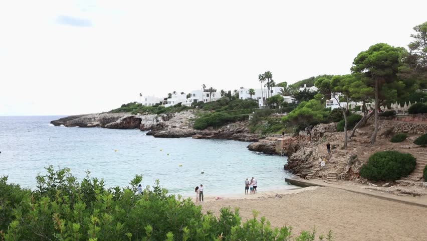 Cala Esmeralda beach in Cala d'Or village on Mallorca island in Spain. Beatuful bay with many white villas and green plants growing on the seaside