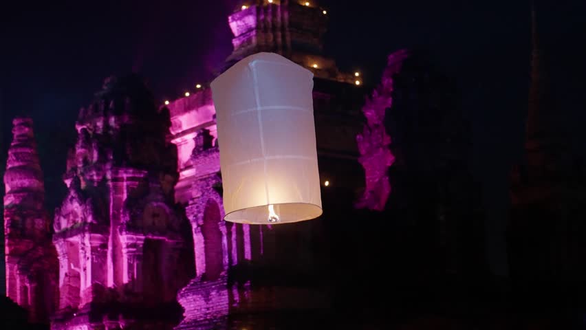 Paper flying lantern lights with flame floating lamps in night sky, Amazing sky lanterns lifting up into the night sky