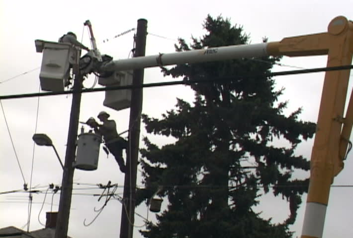 People from power company repairing power line in clip series.