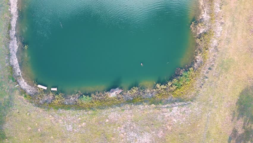 Aerial top down of forest and pond running trail in suburban Baldwin Jacksonville Florida USA