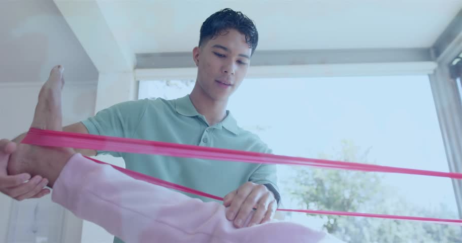 Therapist picking red band and guiding patient extending leg with translucent overlay for therapy. Rehabilitation, physiotherapy, exercise, wellness, support, engagement, clinical