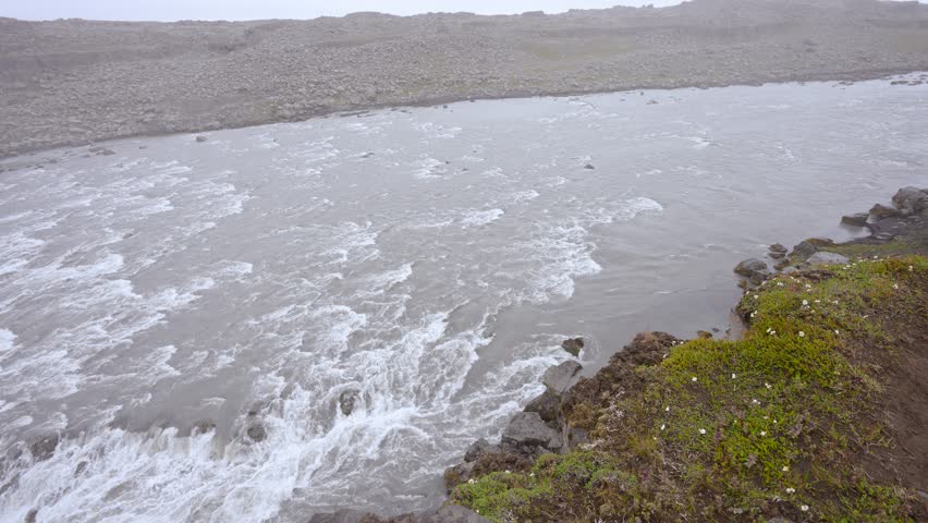 Behold Dettifoss Waterfall Iceland from a side view, showcasing its mighty flow in Vatnajokull National Park, Europe