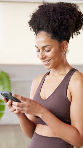 Phone, smile and woman in gym scroll for communication online with mobile app. Fitness, yoga studio and female person with technology for networking or contact on social media in pilates class
