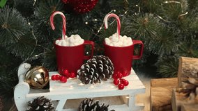 Holidays with minimalist red clay mugs brimming with hot chocolate, marshmallows, candy canes, set on rustic white sleigh surrounded by pinecones, logs, greenery for Nordic-inspired festive vibe. - Powered by Shutterstock - Get 15% off with code: PIKWIZARD15