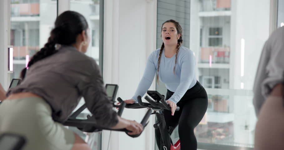 Cycling, fitness and personal trainer in spin class for cardio training, challenge or performance. Exercise, instructions and routine with woman coach in gym for endurance workout on stationary bike