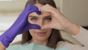 Doctor and patient are doing heart with hands in office. The doctor is grateful for the trust - Powered by Shutterstock - Get 15% off with code: PIKWIZARD15