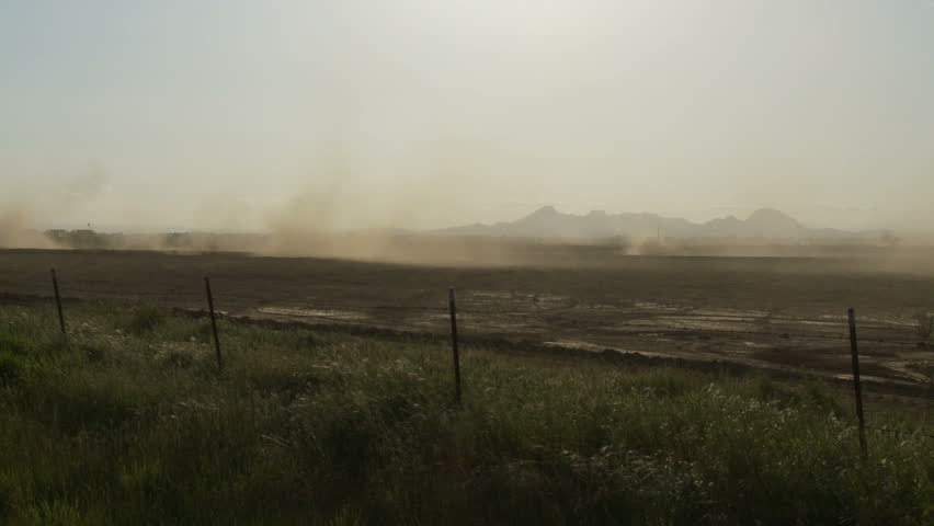 Tractor stirs up dust in field