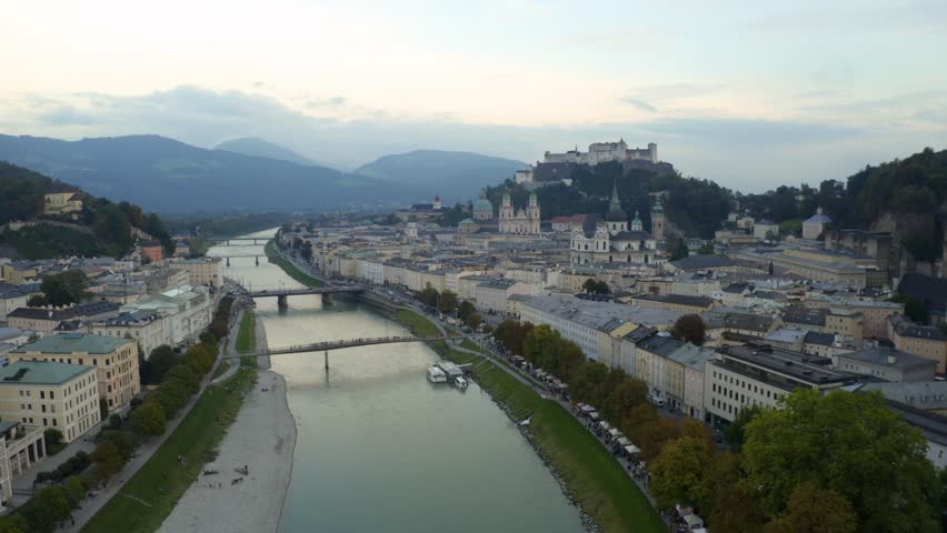 Explore Salzburgs beauty from above in stunning 4K with mountains as a backdrop