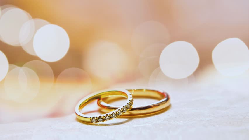 A beautiful couple's ring shot symbolizing a new engagement, placed on a soft blurred background. Perfect for wedding announcements and romantic content.
