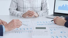 Business people professionals in a meeting analyze financial reports, charts and graphs on laptop and paper, using calculator to discuss strategy, budgeting and teamwork decisions - Powered by Shutterstock - Get 15% off with code: PIKWIZARD15
