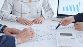 Business people professionals or accouters analyzing financial reports, charts and graphs on laptop and paper, using calculator to discuss strategy, budgeting and teamwork decisions - Powered by Shutterstock - Get 15% off with code: PIKWIZARD15