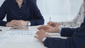 Professional women collaborating in workplace, reviewing financial analytics on digital devices and printed reports, sharing strategic insights - Powered by Shutterstock - Get 15% off with code: PIKWIZARD15